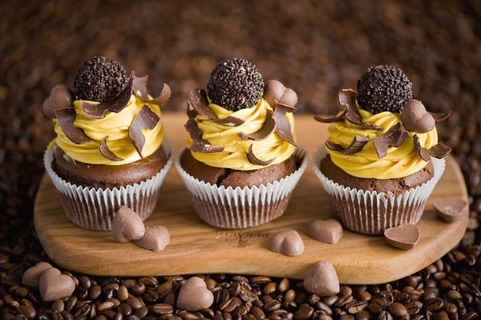 Chocolate cupcakes with yellow frosting and chocolate decorations