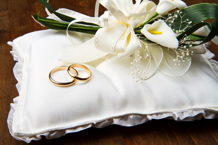 Wedding Rings on a White Pillow with Callas and Bow