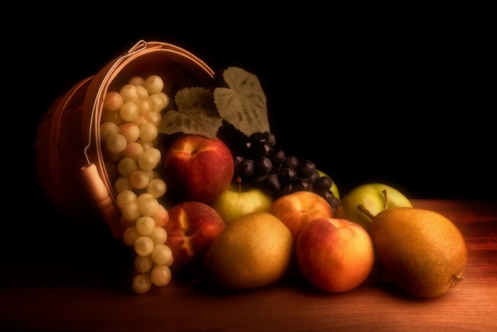 Still-life of apples, grapes, and pears in a basket