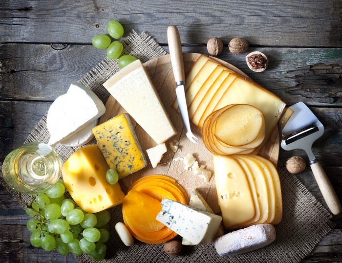 Cheese, Grapes, and Nuts on Wooden Table