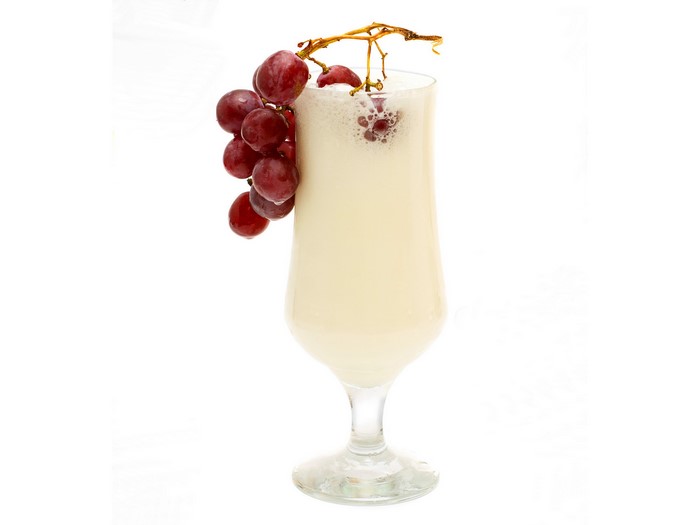 Creamy drink with grapes in a stemmed glass