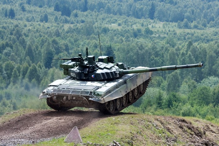 T-90 tank driving on a dirt hill