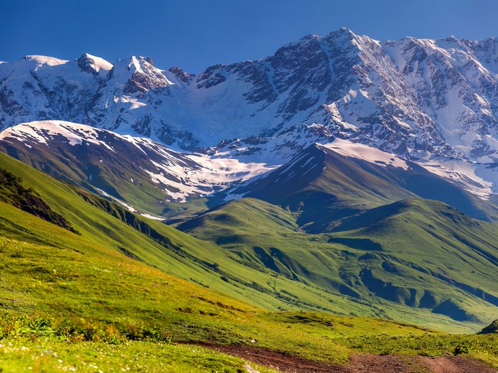 Snow-capped mountains and green valleys