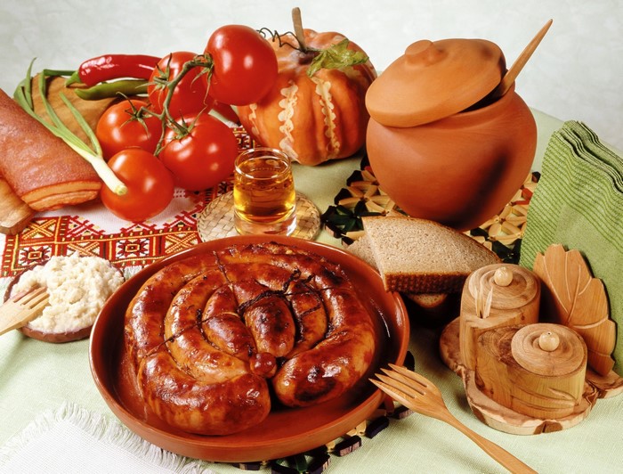 Still-life with sausage, tomatoes, bread, and shot glass