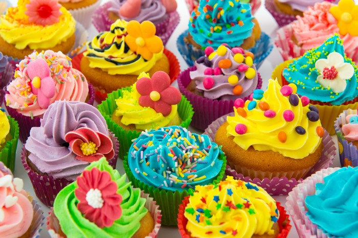 Assortment of colorful cupcakes with frosting and sprinkles
