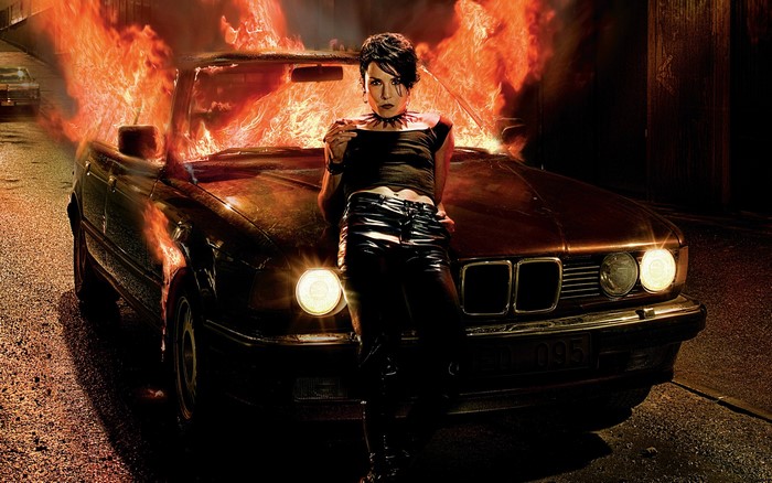 Lisbeth Salander from The Girl Who Played with Fire with a burning BMW
