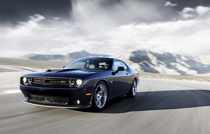 Blue Dodge Challenger SRT Supercharged driving on a road