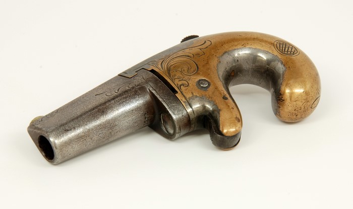 Antique Deringer pistol with ornate engraving