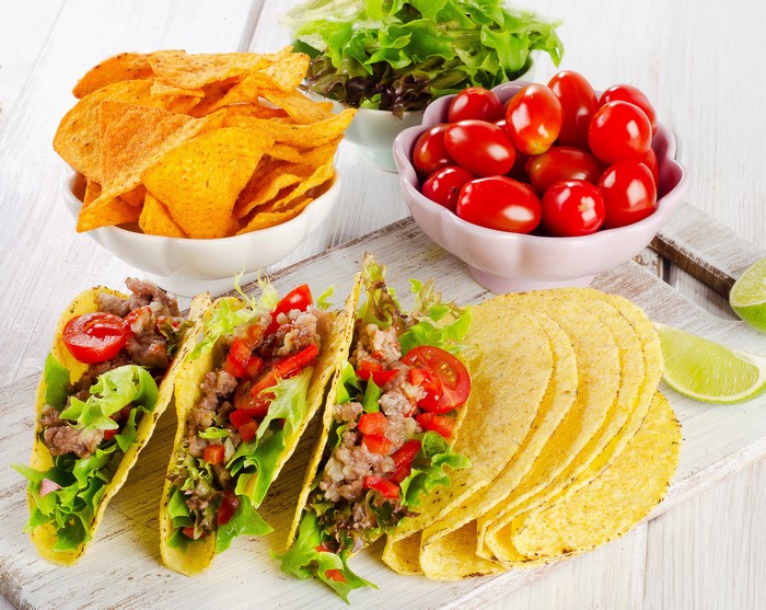 Tacos with chips, tomatoes, and salad