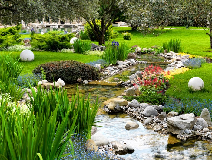 Park stream with grass, shrubs, and stones