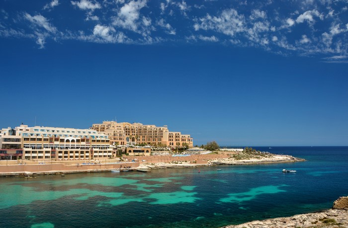 Buildings on the coast of Malta overlooking the sea