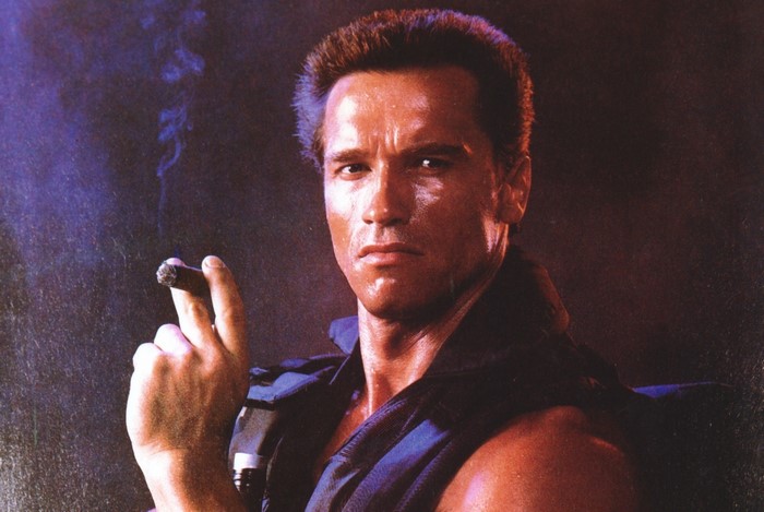Arnold Schwarzenegger as Commando smoking a cigar
