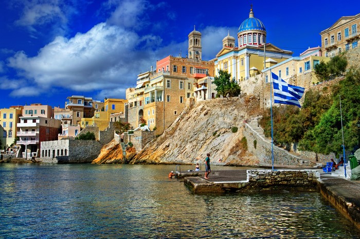 Houses on a cliff overlooking the sea in Greece