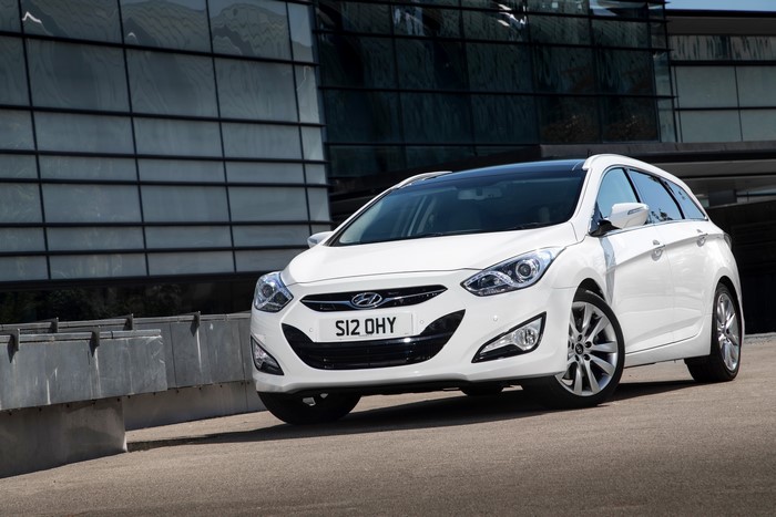 White 2014 Hyundai i40 Tourer parked outside modern building