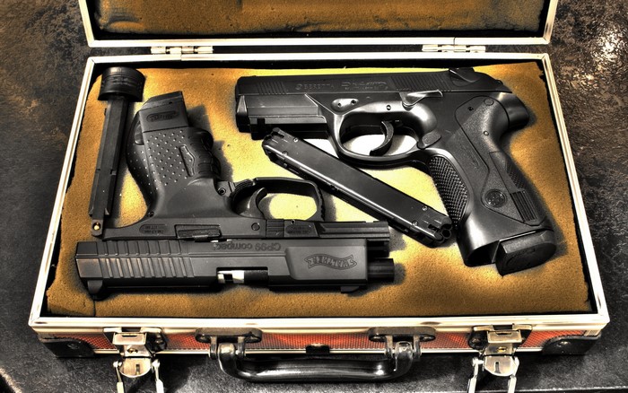 Beretta and Walther pistols in a case