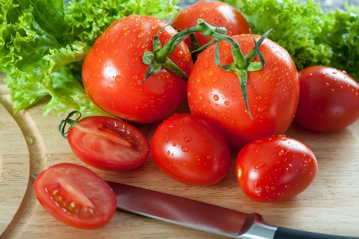Tomatoes and Lettuce on a Cutting Board