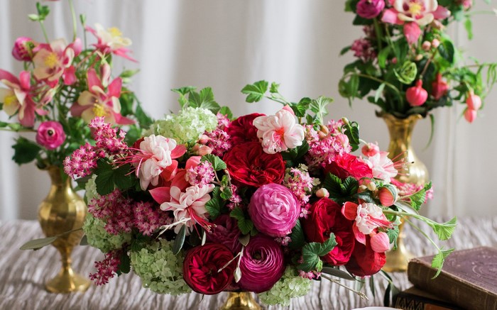 Floral arrangement with roses, ranunculus, and fuchsia