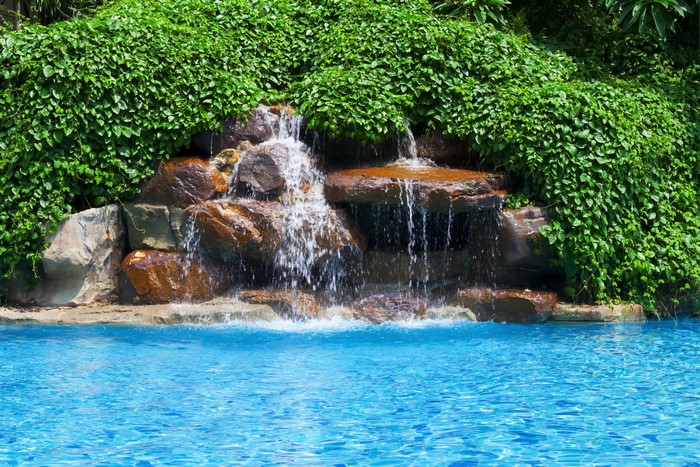 Waterfall cascading into a swimming pool