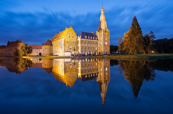 Raesfeld Castle reflected in water at dusk