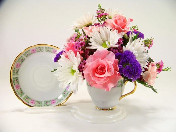 Floral arrangement in a teacup with a saucer