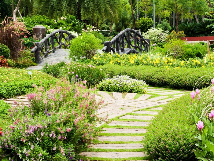 Garden with stone path and wooden bridge