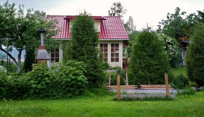 House with red roof and garden in Russia