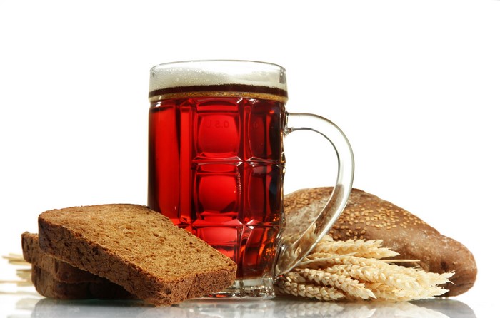 Beer in a mug with bread and wheat