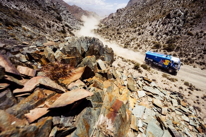 KAMAZ truck racing in Dakar Rally through rocky terrain