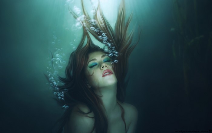 Woman underwater with bubbles