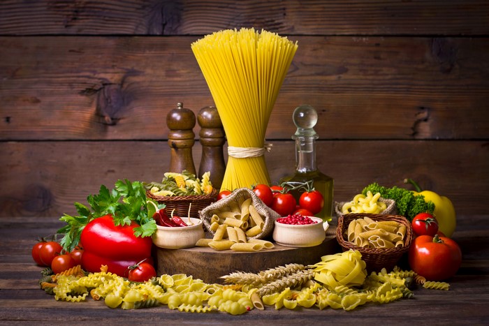 Still-life of pasta, tomatoes, bell pepper, and oil
