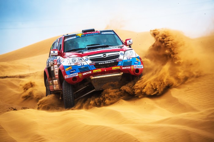 Opel Rally Car Racing Through Sand Dunes at Silkway Rally 2013