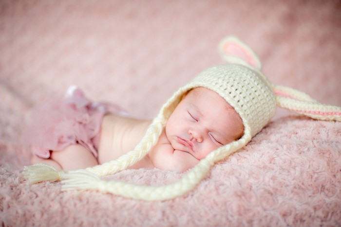 Newborn baby sleeping in a bunny hat