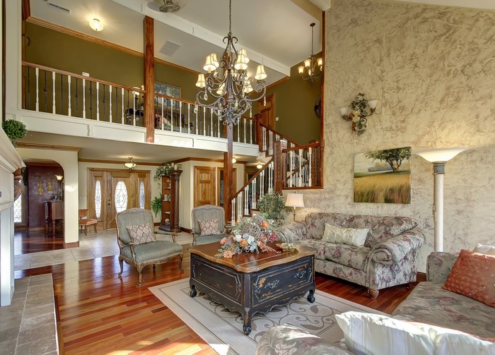 Interior of a living room with a chandelier and stairs