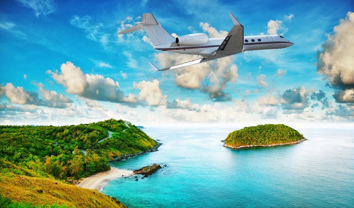 Airplane flying over tropical islands and ocean