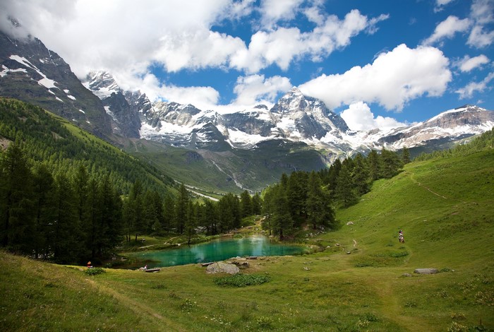 Turquoise lake in the Alps with snow-capped mountains