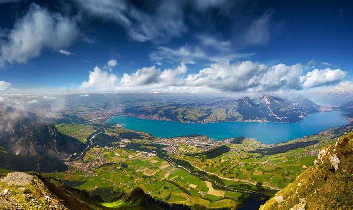 Panoramic view of a lake and mountains under a cloudy sky