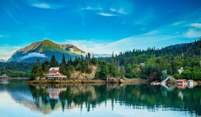 Houses on a forested island with a mountain in Alaska