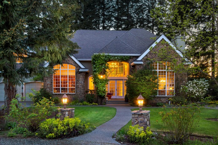 Cozy Evening House with Lit Windows and Garden
