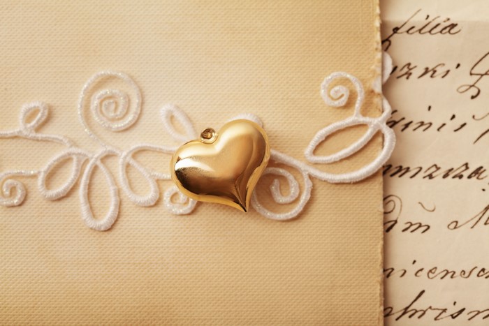 Golden Heart Charm on Lace and Old Letter