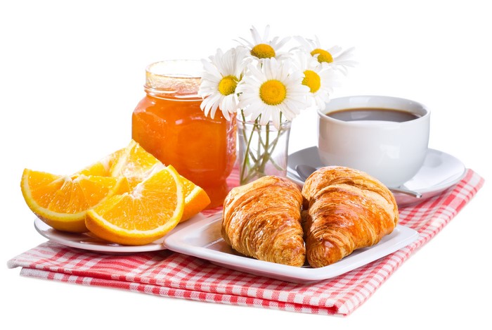 Breakfast with croissants, orange jam, and coffee