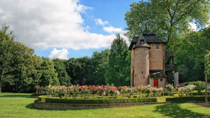 Coloma Rose Garden in Belgium with a brick tower