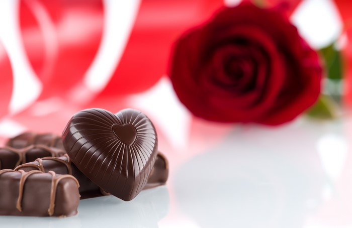 Heart-shaped chocolates and red rose