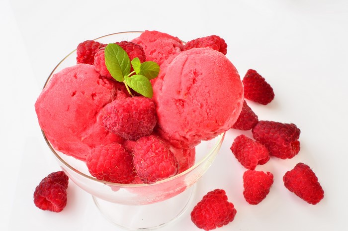 Raspberry ice cream with fresh raspberries and mint