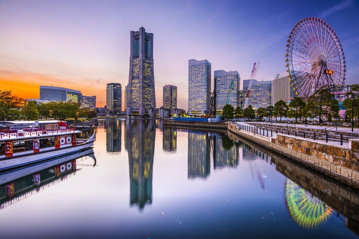 Yokohama skyline with Ferris wheel and boat at sunset