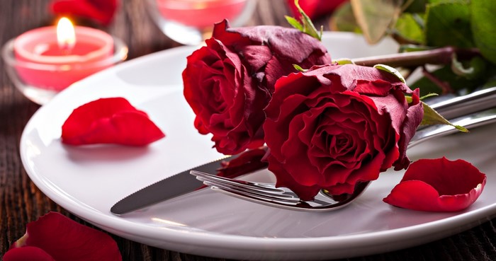 Romantic Dinner Setting with Red Roses and Candles
