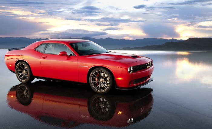 Red Dodge Challenger SRT Supercharged parked on wet surface