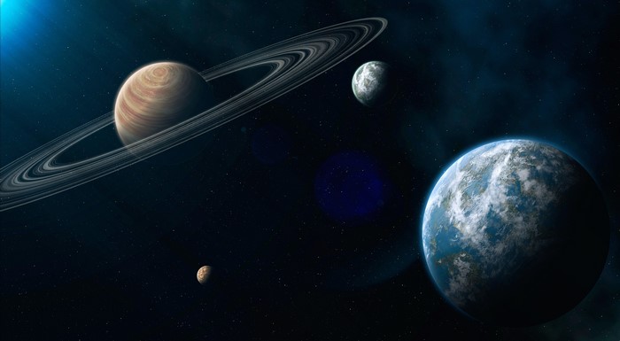 Planets with rings and moons in space