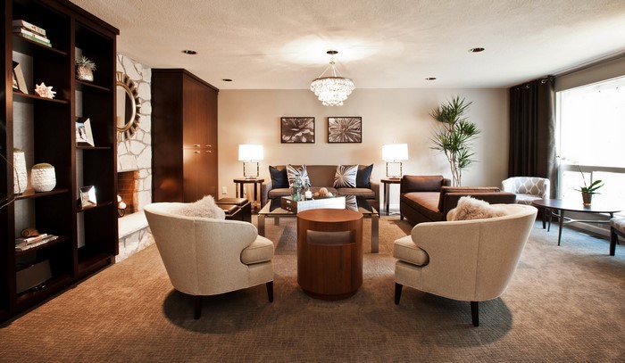 Living room with armchairs, sofa, and chandelier