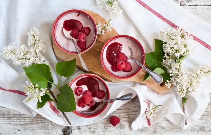 Raspberry dessert with lilac and spoons