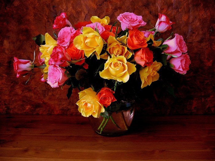 Bouquet of colorful roses in a glass vase